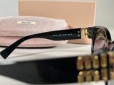 a pair of sunglasses sitting on a table next to a pink case