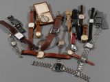 a lot of watches that are sitting on a table