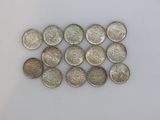 some silver coins are arranged in a row on a white surface