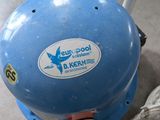 a blue ball that is sitting on the floor next to a fire hydrant