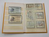 an open book with stamps on it on a table