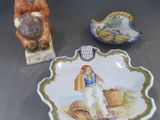 une assiette ornée d'une figurine représentant un homme et un bol sur lequel est représenté un oiseau