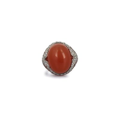 an oval coral and diamond ring
