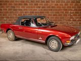 an image of a red sports car parked in a garage