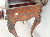 a small wooden table with a mirror on it