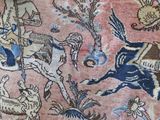 a close up of a rug with a picture of a man on a horse