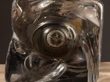 a glass block with a metal object inside of it