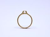 a close up of a gold ring on a white background