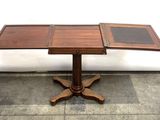a wooden table with a glass top sitting on a tile floor
