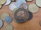 a pile of coins sitting on a table with a coin on top of it