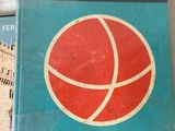 a book on a shelf with a basketball ball on it