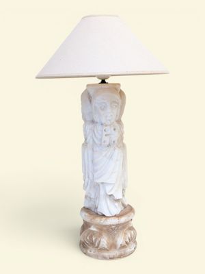 une lampe blanche surmontée d'un abat-jour blanc