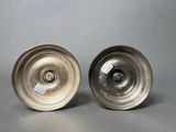 a pair of silver plated dishes on a gray surface