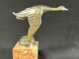 an image of a bronze bird on a marble base