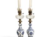 two blue and white vases with candles on top of each other