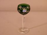 a wine glass with a green and white design on it