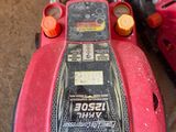 a red lawn mower that is sitting on the ground