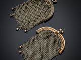 two antique mesh purses on a black background