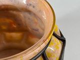 a close up of a vase on a white surface