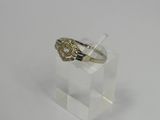 a close up of a gold ring on a clear acrylic stand