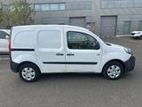 a white van parked in a parking lot next to a building