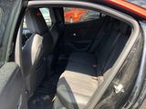 the back seat of a car with the door open and the passenger seat down