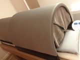 a bed with a pillow on top of it in a room
