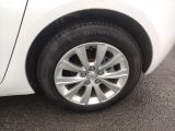 a close up of a tire on a white car