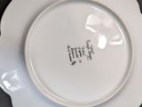 a white plate with writing on it sitting on a table