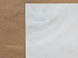 a white piece of paper on a brown surface