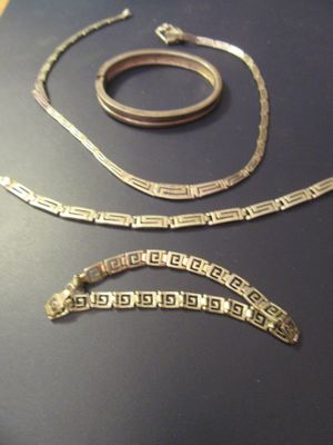 two pieces of jewelry that are on a table