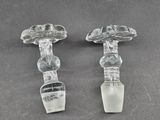 pair of clear glass candlesticks sitting on top of a table