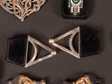 many different types of jewelry on a black surface