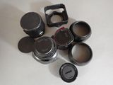 a lot of camera lenses sitting on a table