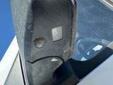 a side view mirror on the side of a white car
