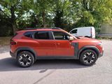 a red suv parked in a parking lot with trees in the background