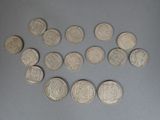 several silver coins are arranged in a circle on a gray surface