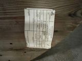 a piece of paper on a wooden table with a knife