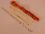 three different types of necklaces and bracelets on a table