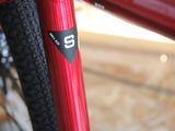 a close up of a red bike with a number on it