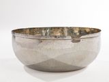 an image of a silver bowl sitting on top of a white table