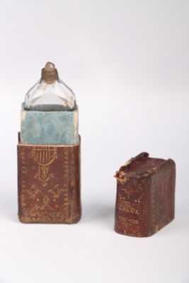 a bottle and a book sitting next to each other on a table