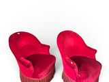pair of red velvet slippers with fringes on a white background