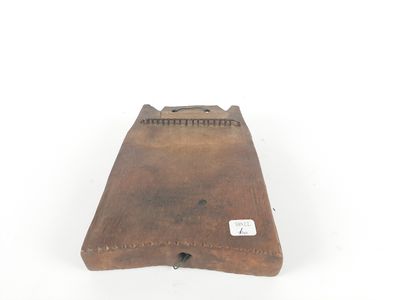 an old wooden box with a label on it sitting on a white surface