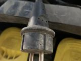 an image of a close up of a car ' s engine with two plugs attached to it