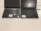 two laptops that are sitting on a white table