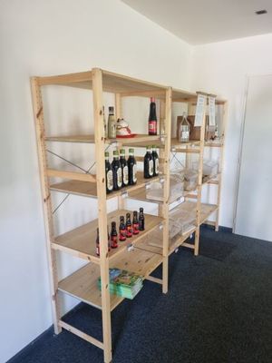 a shelf with bottles of wine on it in a room