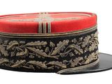 a red and black hat with gold designs on it