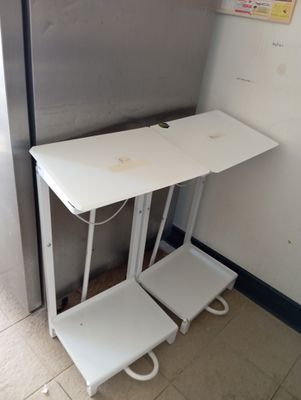 a small white table with two stools next to it