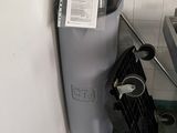 a trash can next to a garbage can in a bathroom